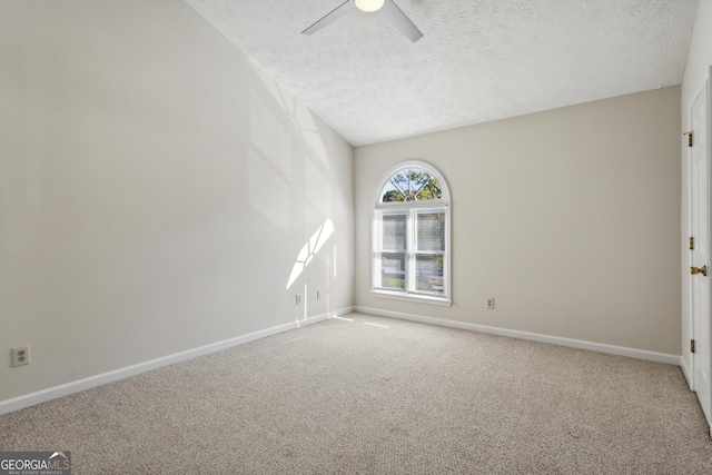 unfurnished room with a textured ceiling and carpet floors