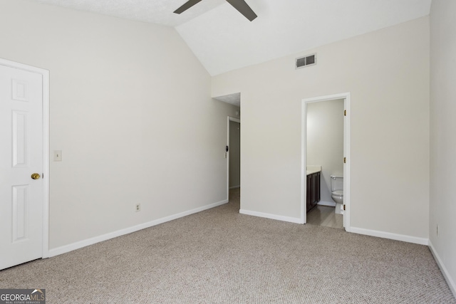 unfurnished bedroom featuring connected bathroom, ceiling fan, light carpet, and vaulted ceiling