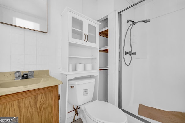 bathroom featuring vanity, toilet, and walk in shower