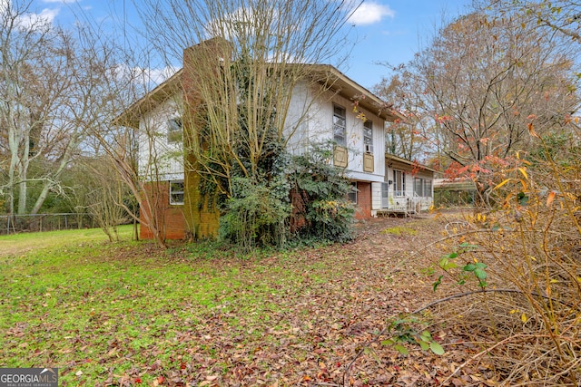 view of side of home featuring a yard