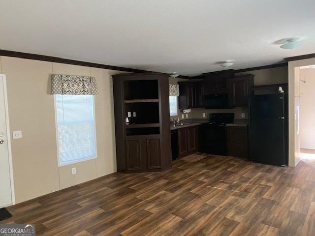 kitchen featuring sink, dark hardwood / wood-style floors, ornamental molding, and black appliances