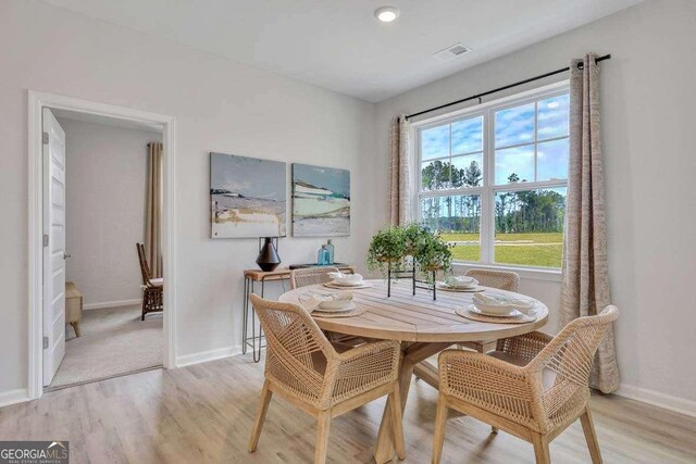 dining space with light hardwood / wood-style flooring