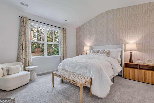 carpeted bedroom with vaulted ceiling