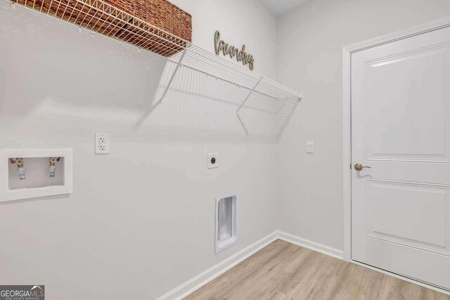 laundry room with electric dryer hookup, washer hookup, and hardwood / wood-style flooring