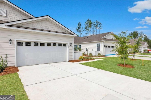 view of front of home with a front lawn and a garage