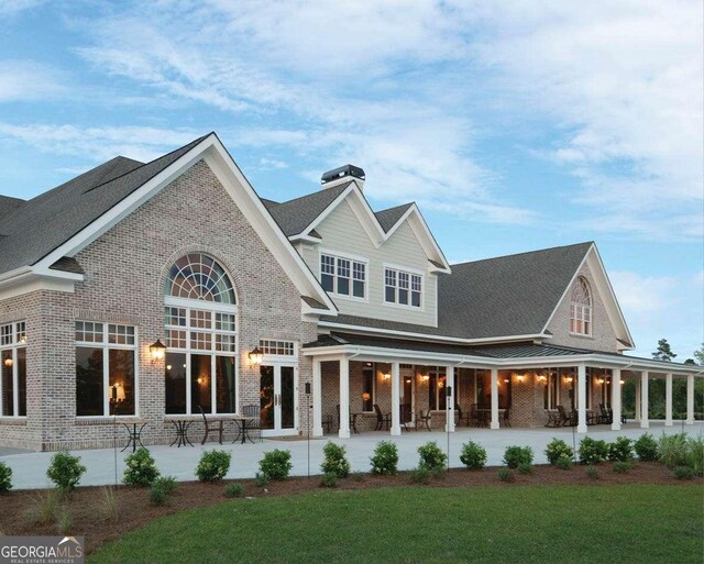 back of property with a patio area and french doors