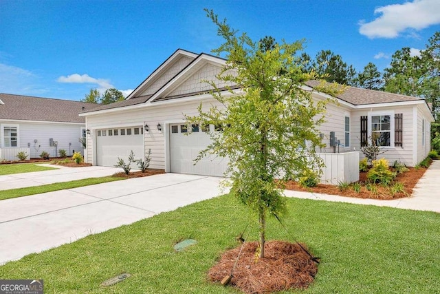 view of front of property with a front lawn and a garage