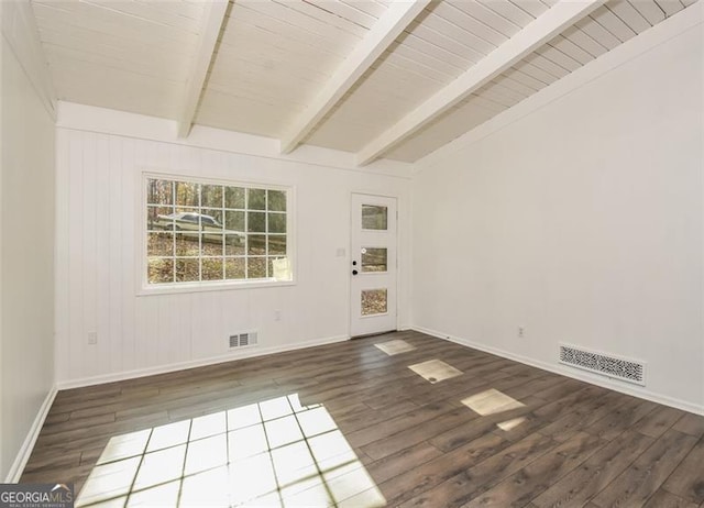 spare room featuring lofted ceiling with beams and wood-type flooring