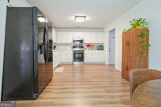 kitchen featuring decorative backsplash, light wood-type flooring, stainless steel appliances, and white cabinetry