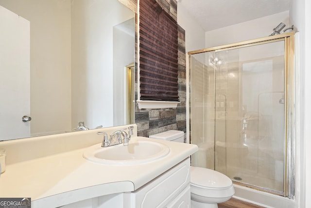 bathroom featuring vanity, toilet, and walk in shower