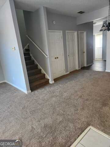 interior space with carpet floors and an inviting chandelier