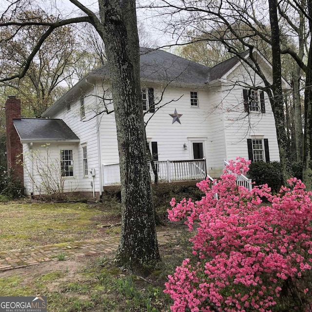 view of home's exterior featuring a wooden deck