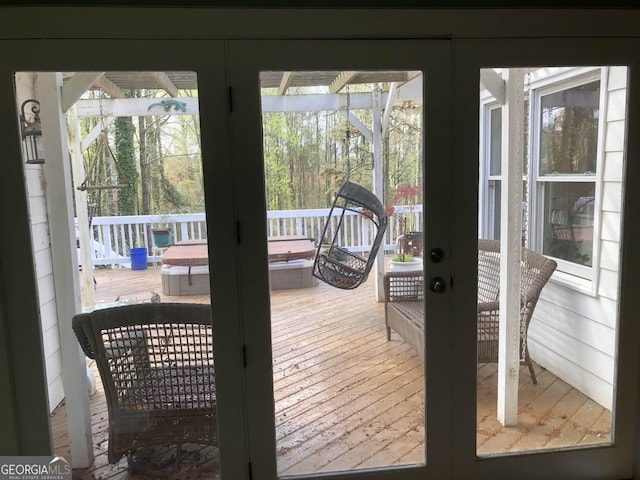 doorway with french doors and a healthy amount of sunlight