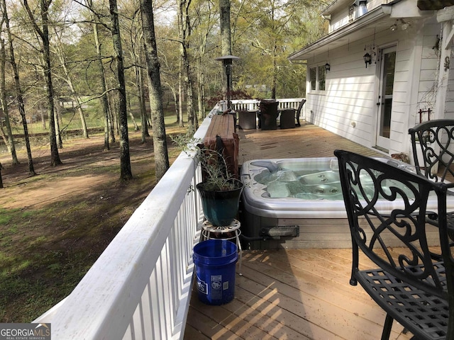 wooden deck with an outdoor hot tub