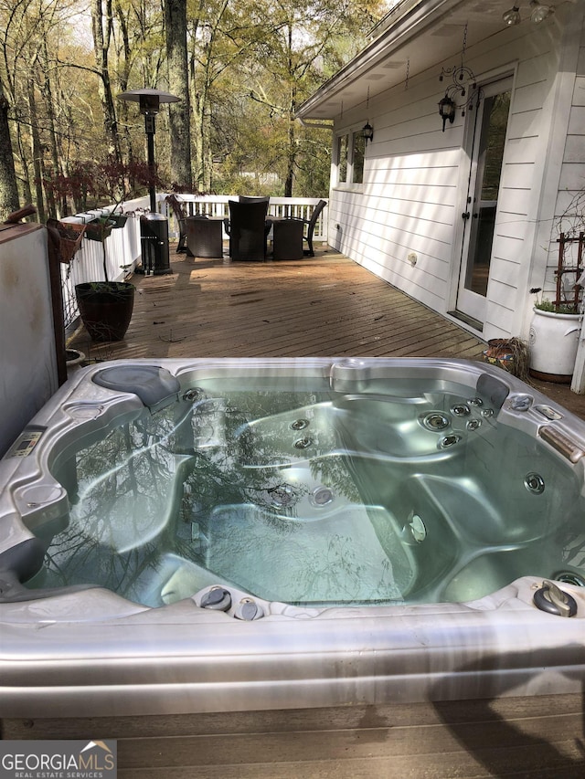 exterior space with an outdoor hot tub