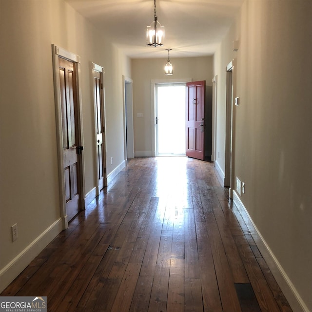 entrance foyer with dark wood-type flooring and a notable chandelier