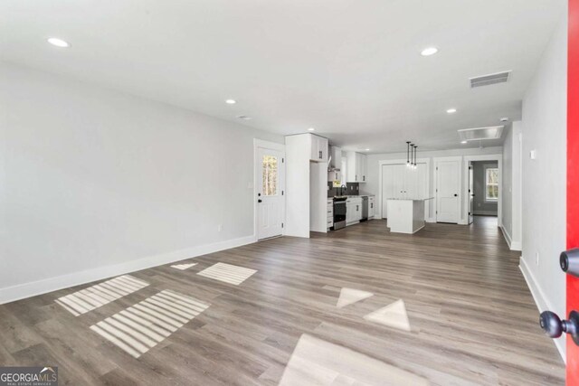 foyer featuring recessed lighting, visible vents, plenty of natural light, and wood finished floors