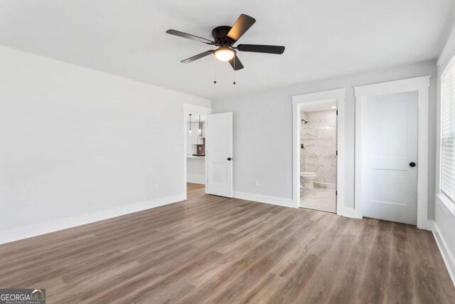 unfurnished bedroom featuring visible vents, baseboards, and wood finished floors