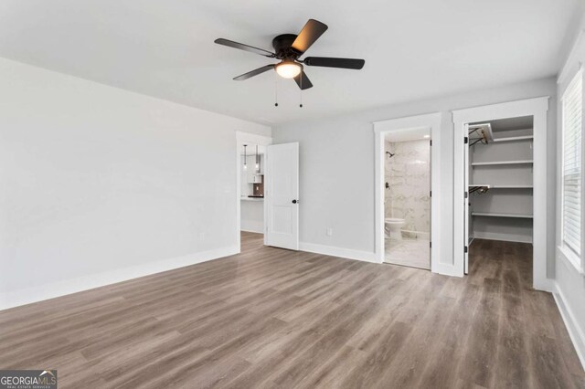 walk in closet with dark wood-style flooring