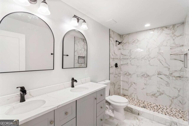 bathroom with a marble finish shower, toilet, marble finish floor, vanity, and recessed lighting