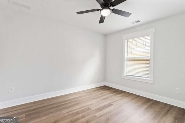 unfurnished bedroom featuring ceiling fan, dark wood-type flooring, visible vents, baseboards, and a closet