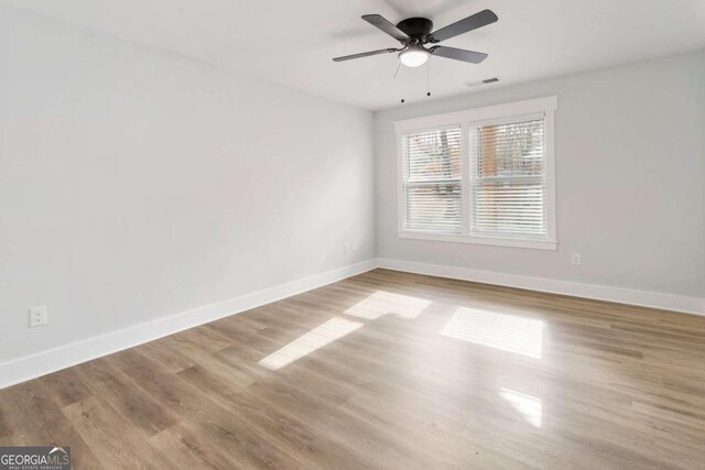 unfurnished bedroom featuring dark wood-type flooring, a closet, electric panel, and baseboards