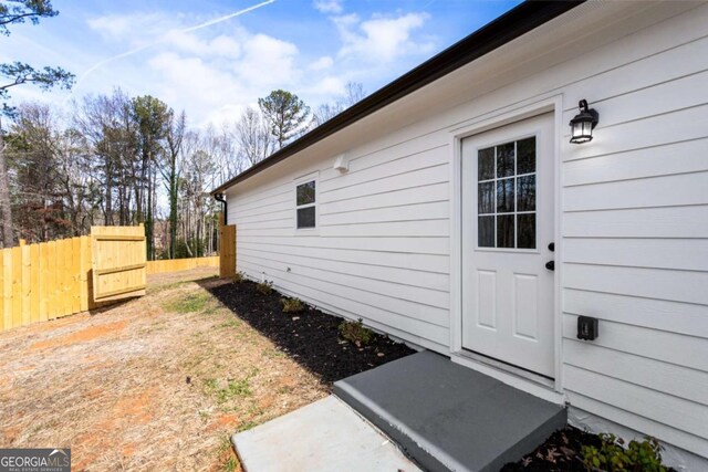 view of side of home featuring fence