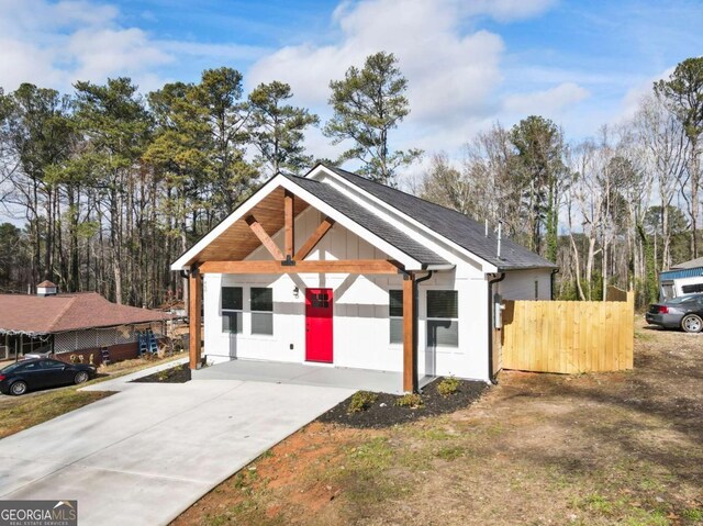 view of front of house featuring roof with shingles and board and batten siding