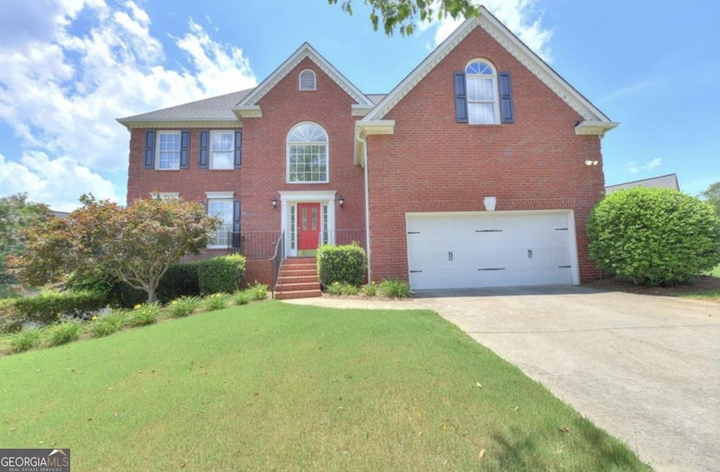 view of front of house with a garage and a front lawn