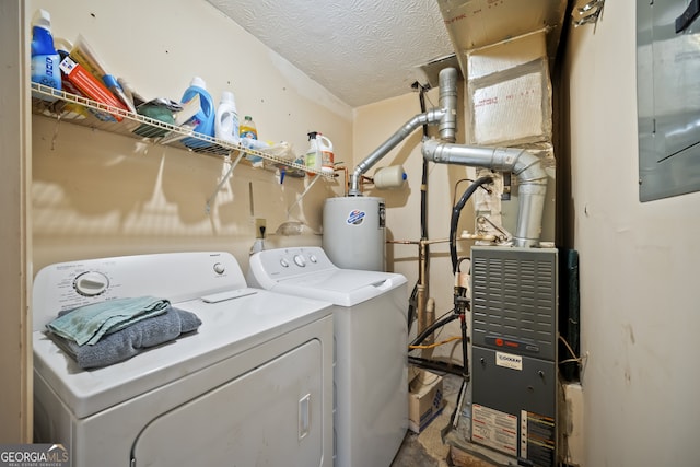 laundry room with a textured ceiling, washing machine and dryer, and gas water heater