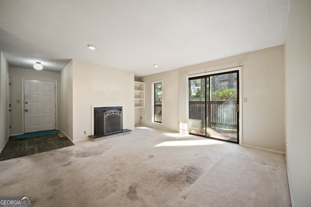 unfurnished living room featuring carpet