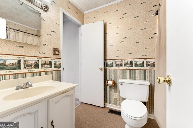 bathroom with vanity, ornamental molding, a textured ceiling, and toilet