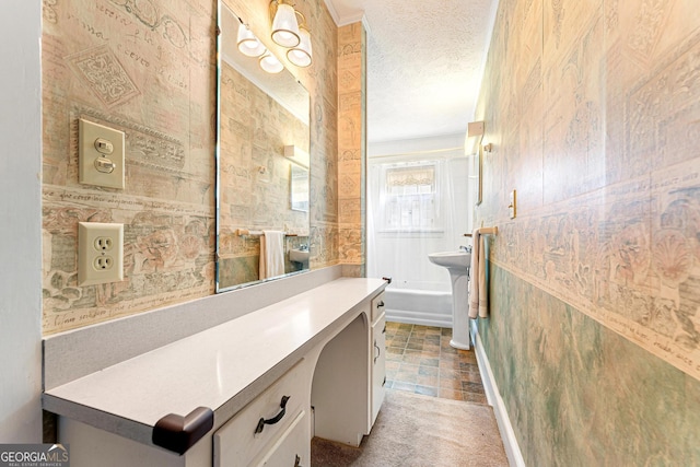 bathroom with sink and a textured ceiling