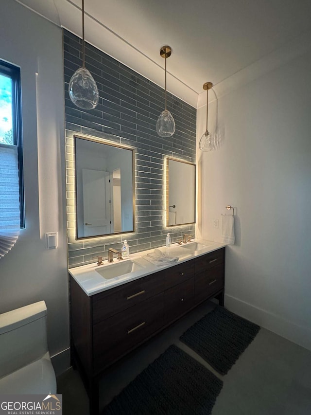 bathroom with tasteful backsplash, vanity, and toilet