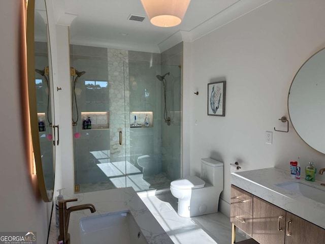 bathroom featuring vanity, toilet, a shower with door, and crown molding