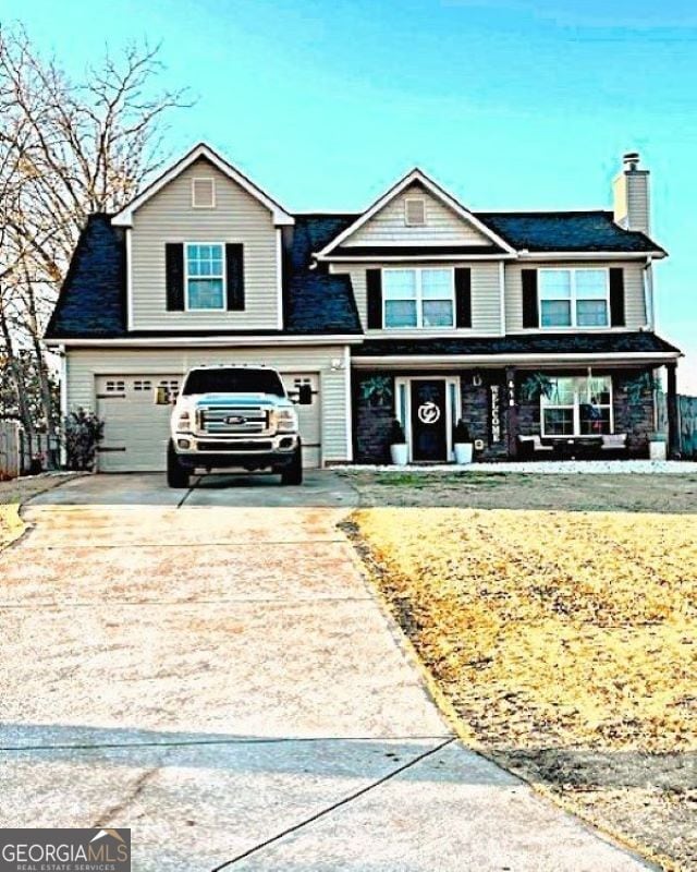 view of front of property featuring a porch and a garage