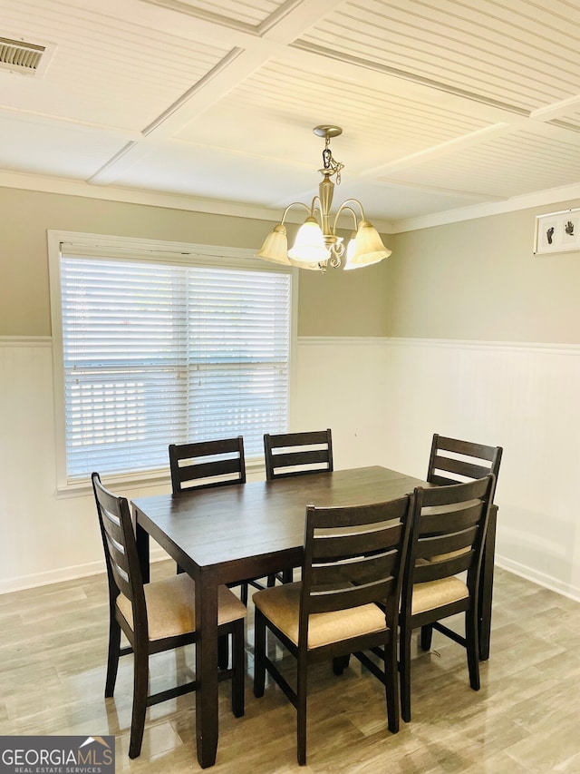 dining space with hardwood / wood-style flooring and a notable chandelier