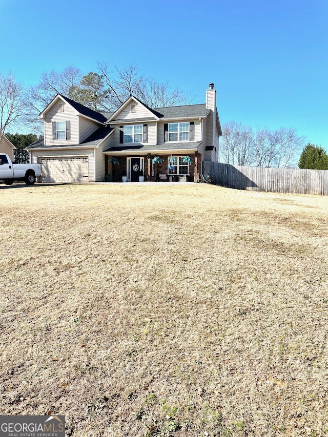 view of front of home with a front yard and a garage