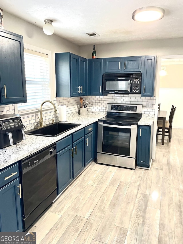 kitchen with sink, blue cabinets, and black appliances