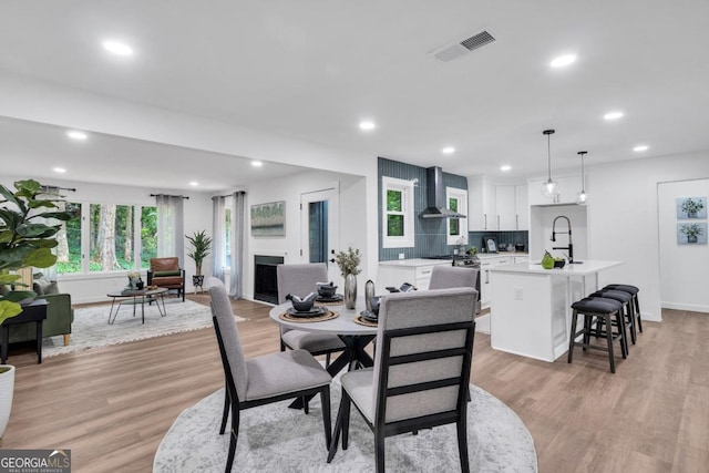 dining room with light wood-type flooring and sink