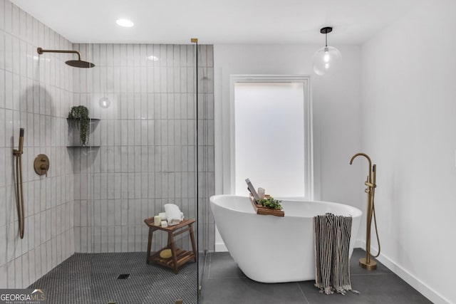 bathroom with tile patterned flooring and separate shower and tub