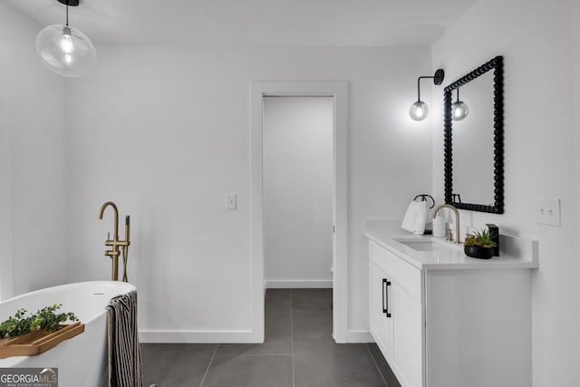 bathroom with tile patterned flooring, vanity, and a bath