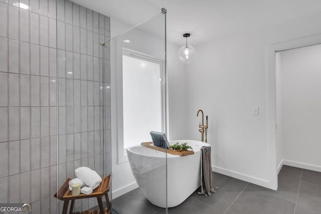 bathroom featuring a tub to relax in and tile patterned floors