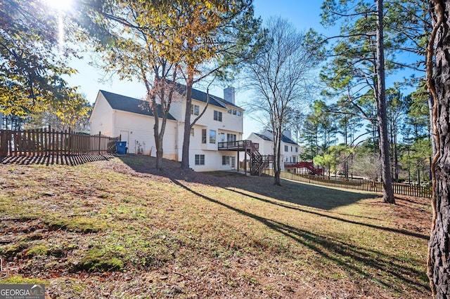 rear view of house featuring a lawn