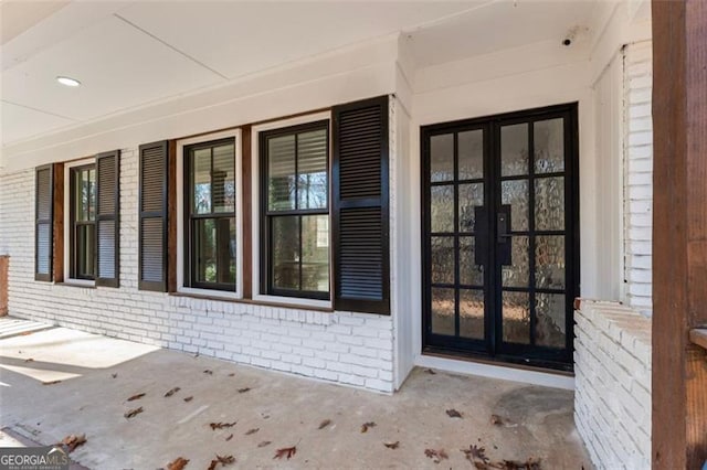 doorway to property featuring french doors and a porch