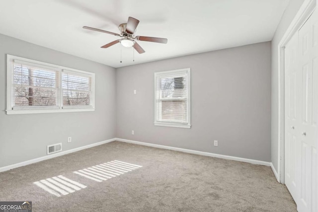 unfurnished bedroom featuring a closet, visible vents, baseboards, and carpet flooring