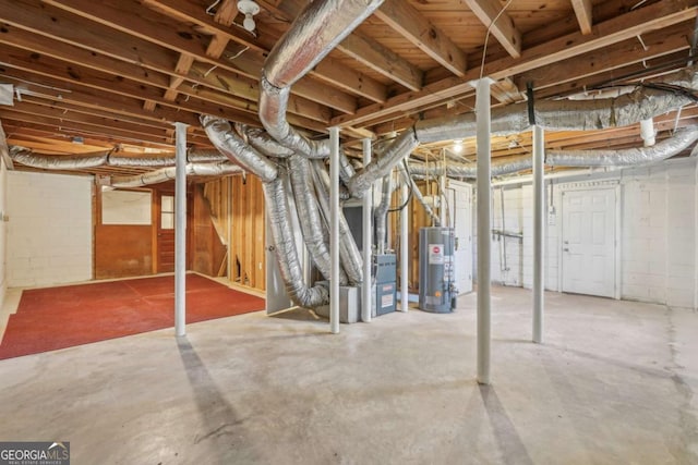 unfinished basement with heating unit, water heater, and concrete block wall