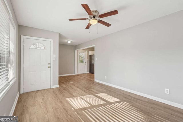 entryway with a ceiling fan, baseboards, and wood finished floors