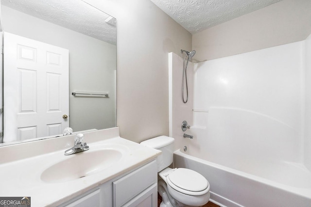 full bathroom with vanity, toilet, a textured ceiling, and shower / washtub combination