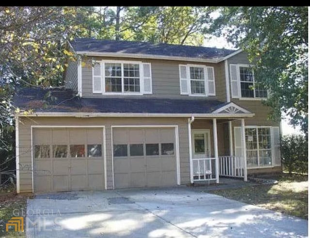 view of front of home with covered porch and a garage